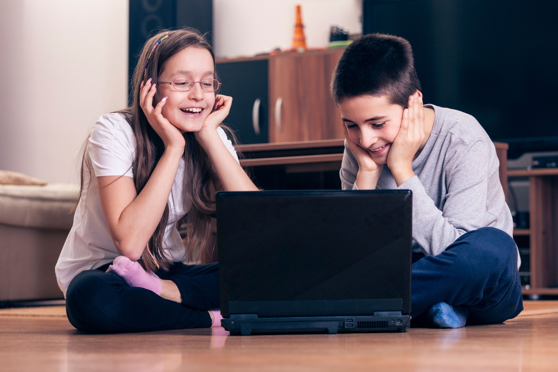 Teenage boy and girl with lap top PC