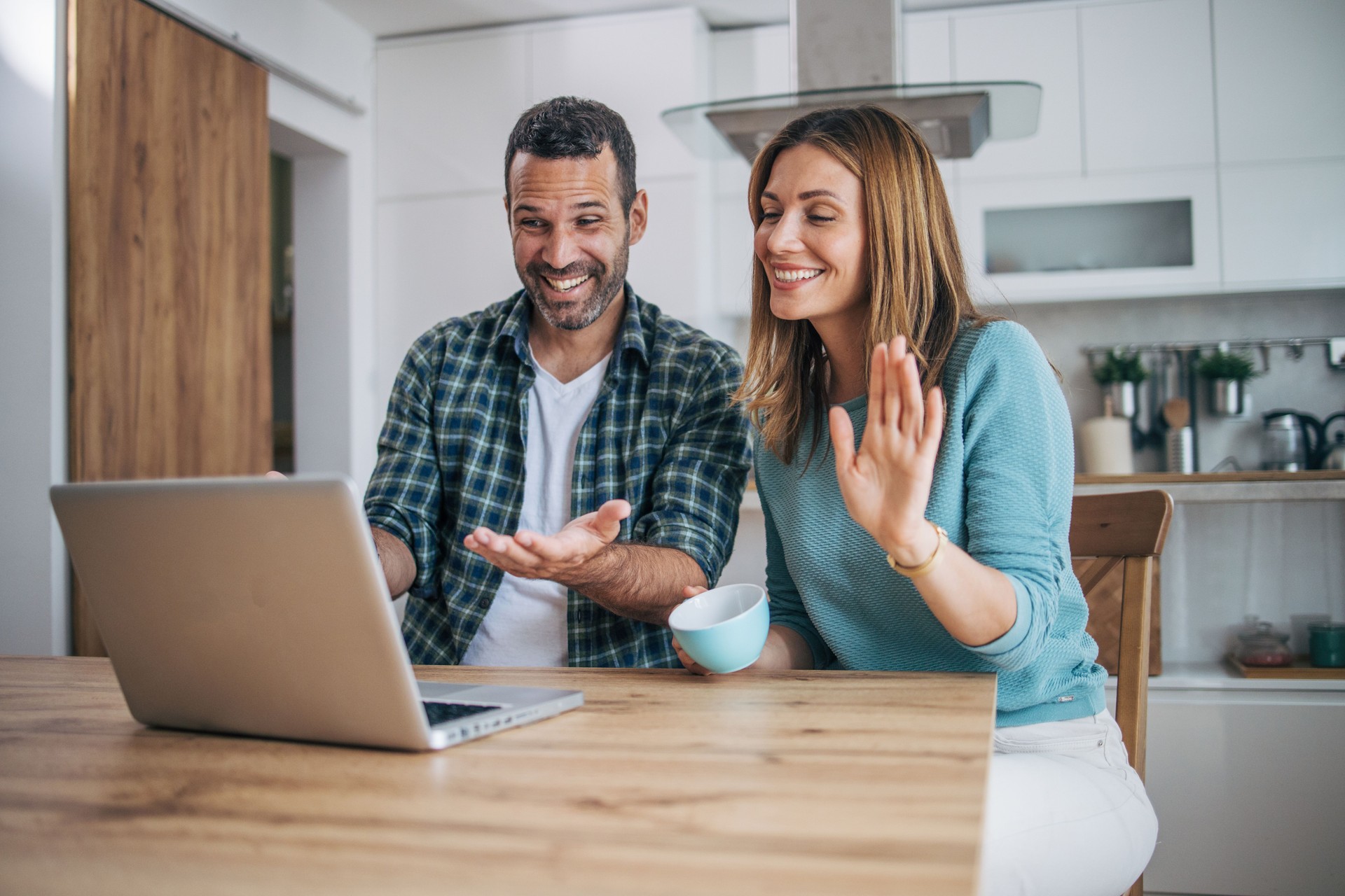 Couple making a video call over the laptop.